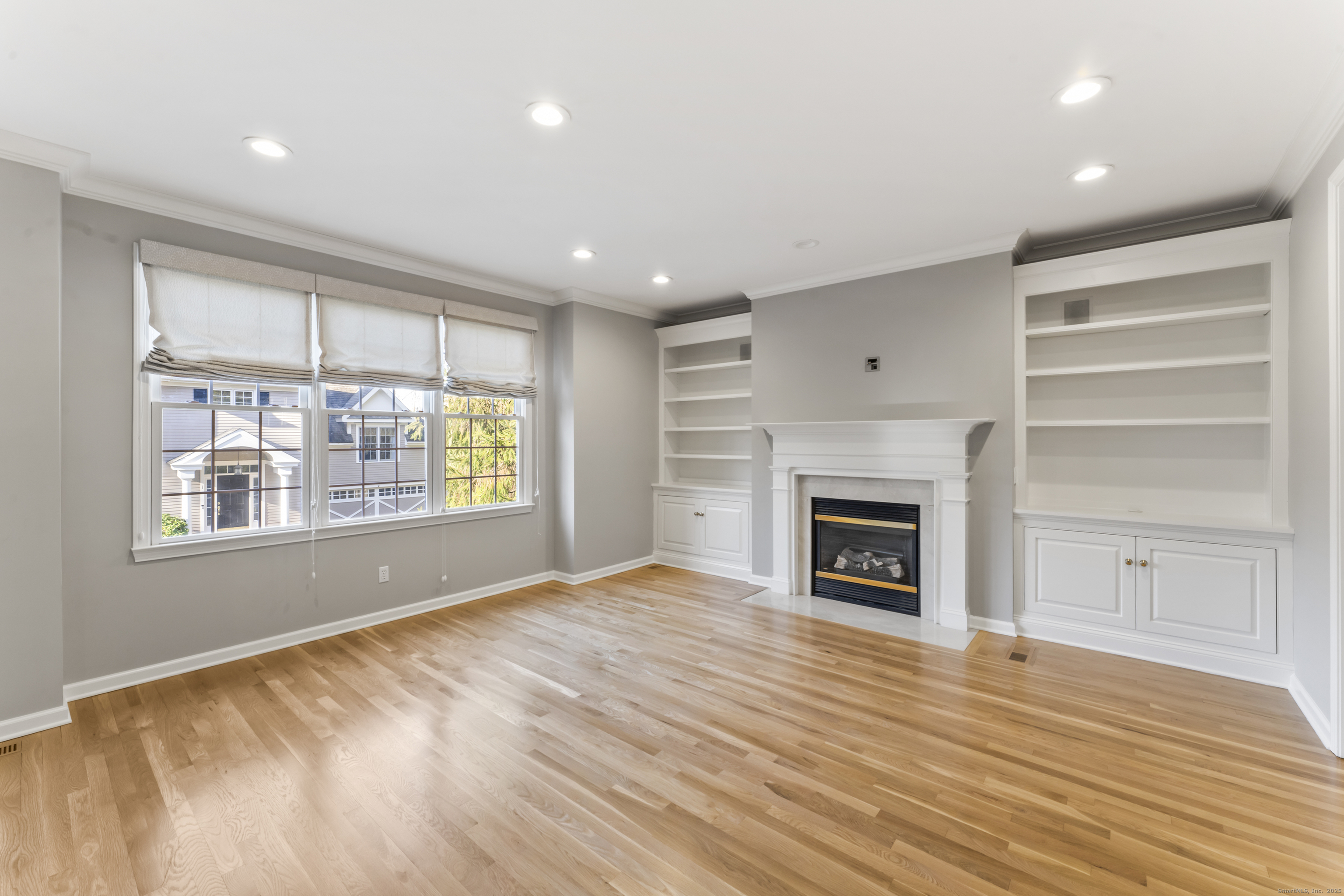 4 Woods Way New Fairfield, CT 06812 - Photo 9 of 39 a view of an empty room with a window and fireplace