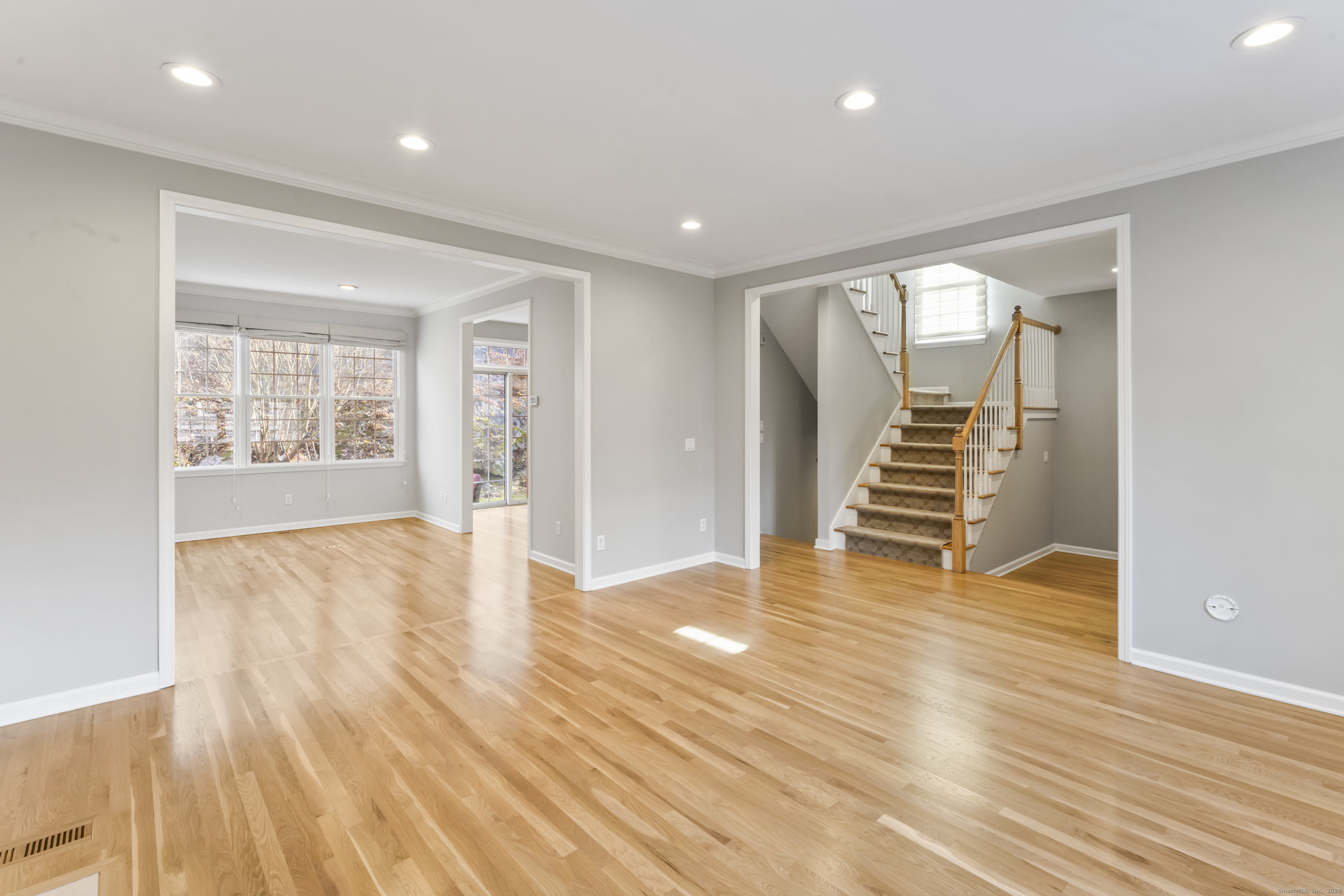 4 Woods Way New Fairfield, CT 06812 - Photo 10 of 39 an empty room with wooden floor and windows