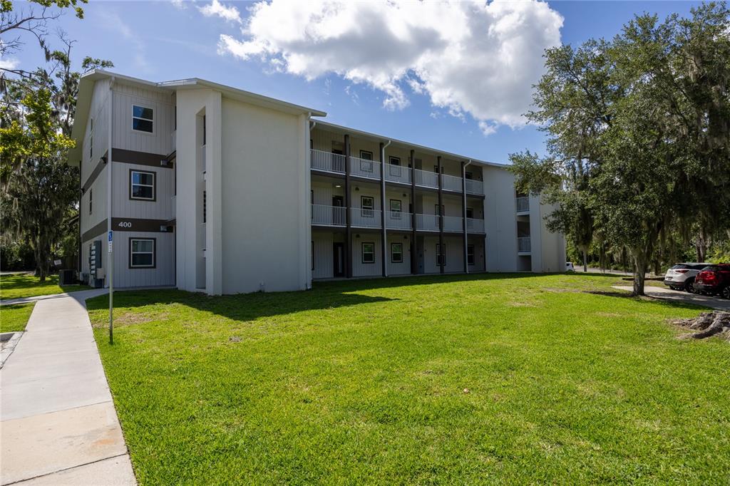 a view of a house with a backyard