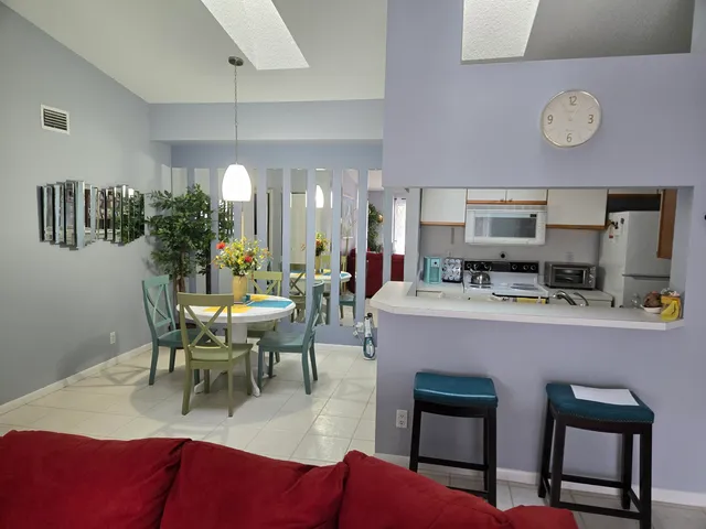 a living room with furniture kitchen view and a table