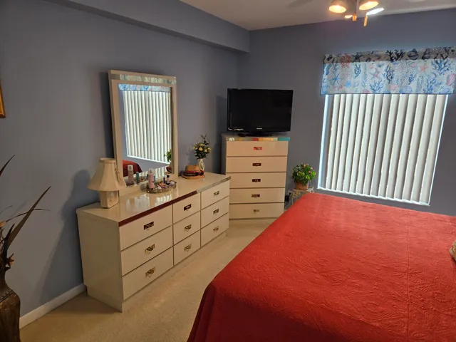 a bedroom with a bed and flat screen tv