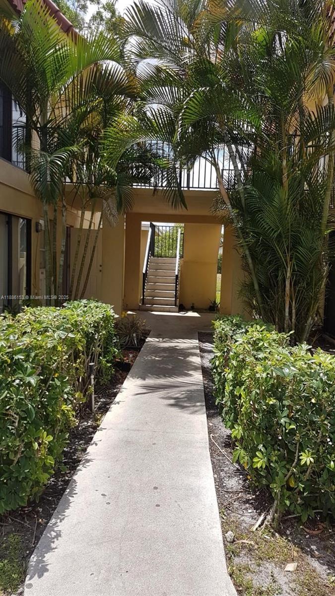 11386 Royal Palm Boulevard, Unit 11386 Coral Springs, FL 33065 - Photo 2 of 10 a front view of a house with a yard