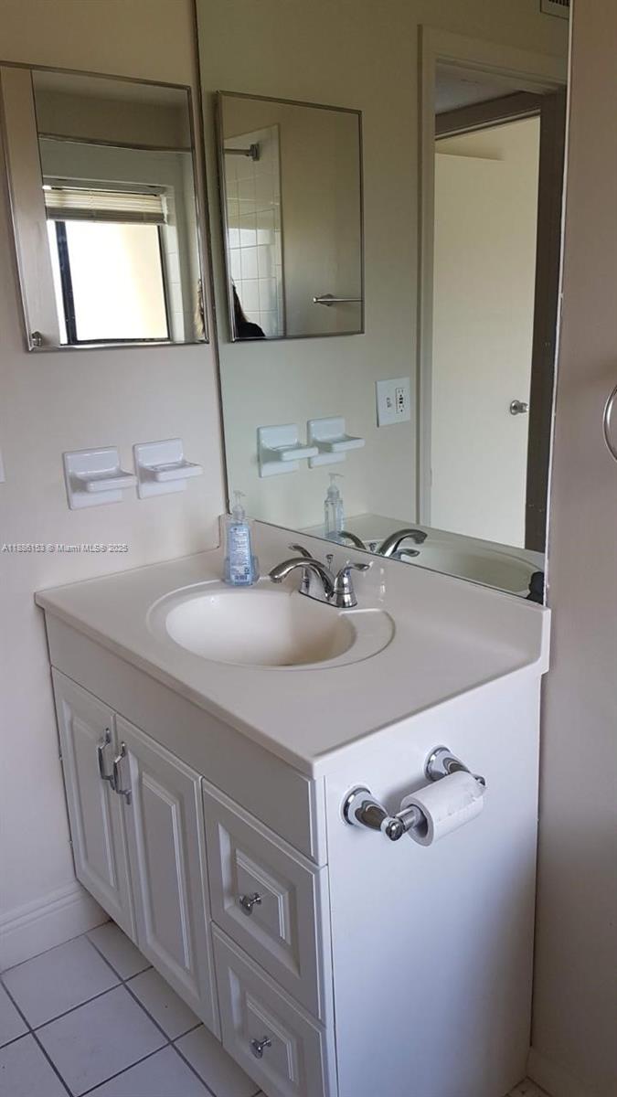 11386 Royal Palm Boulevard, Unit 11386 Coral Springs, FL 33065 - Photo 5 of 10 a bathroom with a sink and a mirror