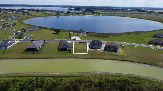 an aerial view of a house with a lake view