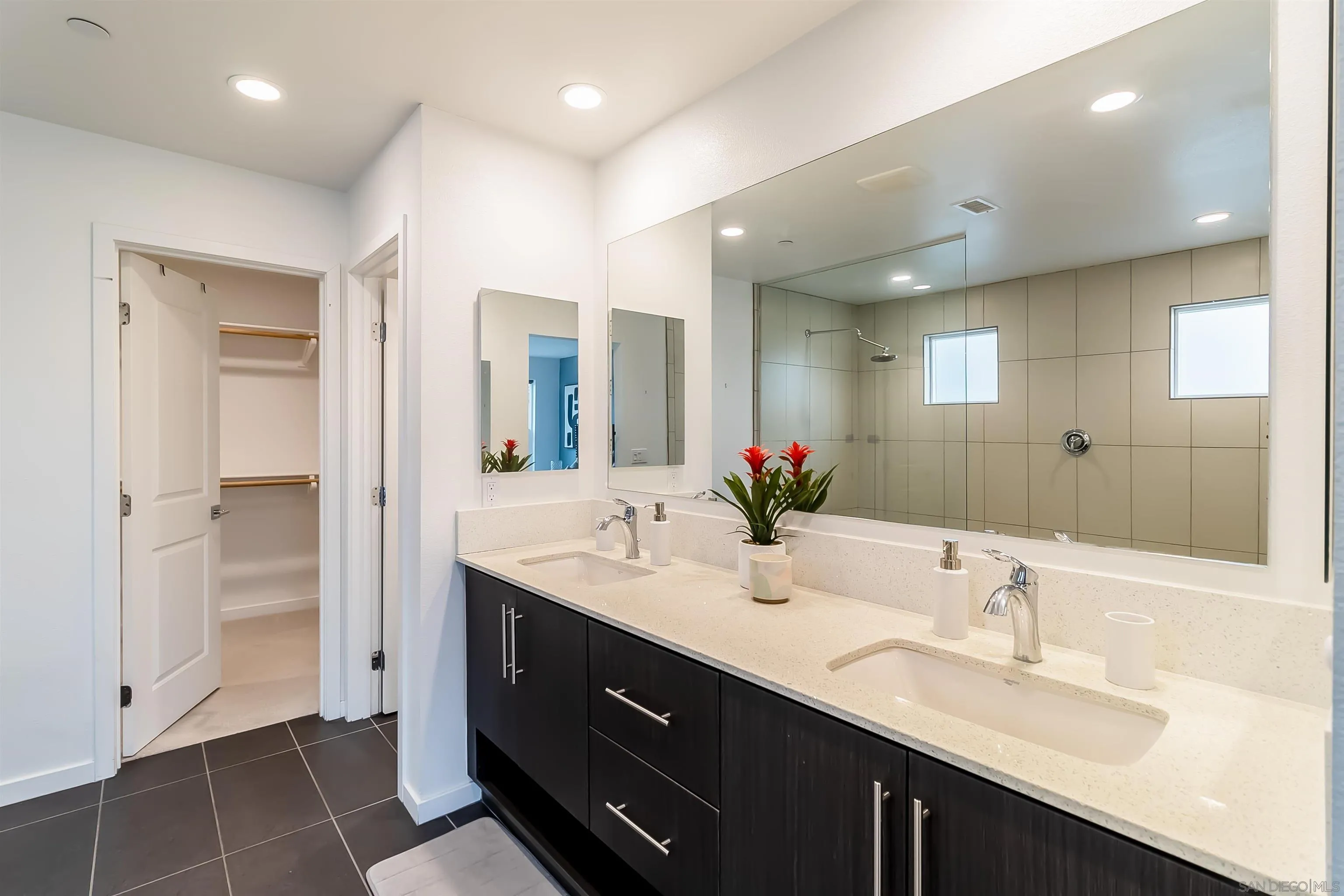 8344 Summit Way San Diego, CA 92108 - Photo 18 of 41 a bathroom with a double vanity sink mirror and shower