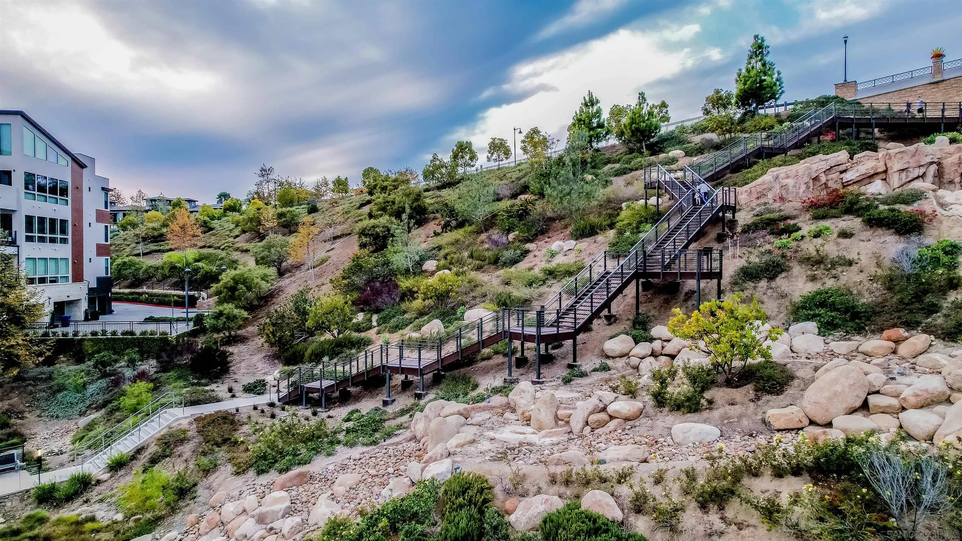 8344 Summit Way San Diego, CA 92108 - Photo 38 of 41 a backyard of a house with a lot of plants and flowers