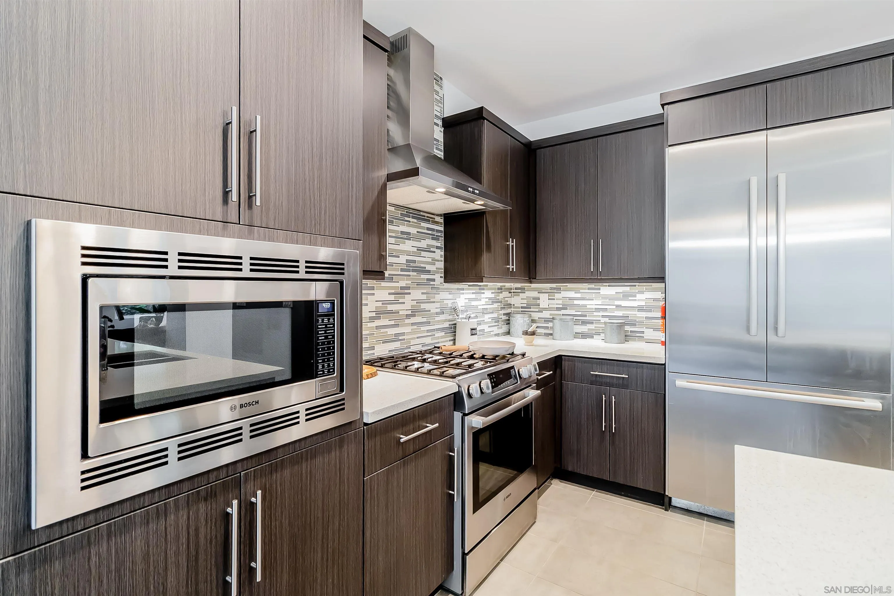 8344 Summit Way San Diego, CA 92108 - Photo 9 of 41 a kitchen with granite countertop a stove microwave and refrigerator