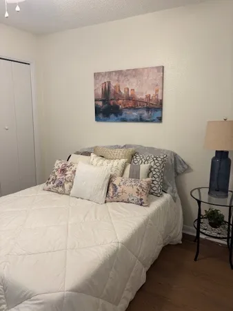 a bedroom with a bed and a chair