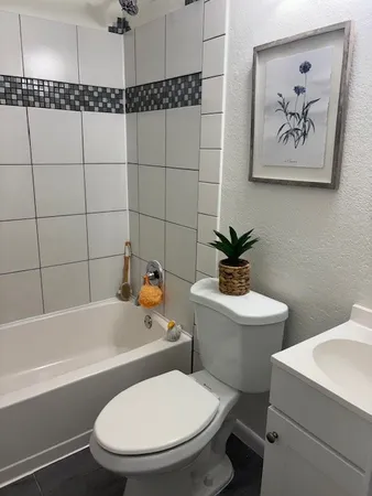a bathroom with a toilet a sink and bathtub