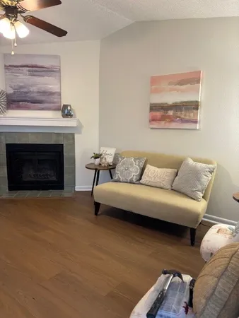 a living room with furniture and a fireplace
