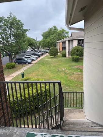 a view of a brick house with a backyard