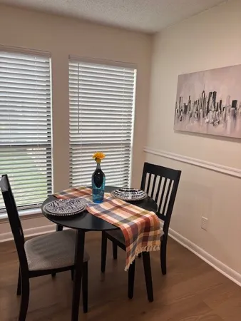 a view of a dining room with furniture and wooden floor