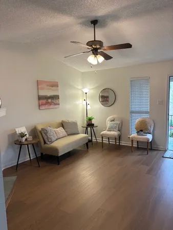 a living room with furniture and a large window