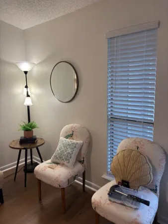 a living room with furniture and a lamp