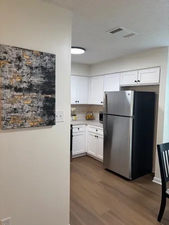 a kitchen with a refrigerator and a stove top oven