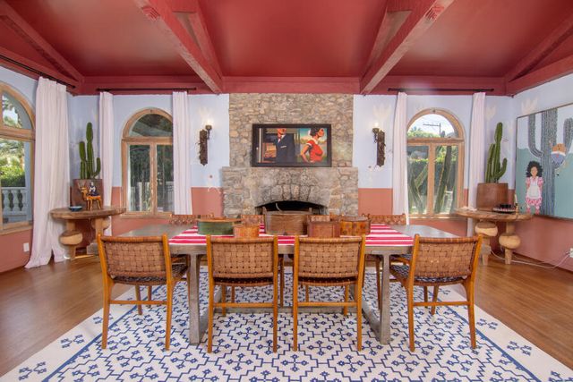 a large white kitchen with stainless steel appliances granite countertop a stove a sink a refrigerator and white cabinets with wooden floor