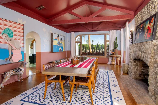 a view of a room with wooden floor and furniture