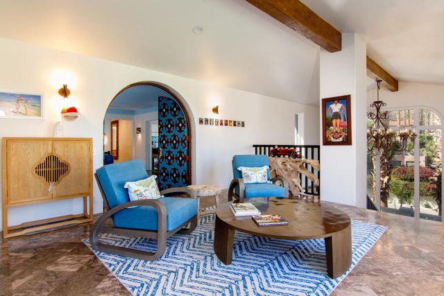 a bedroom with a bed a table and chair