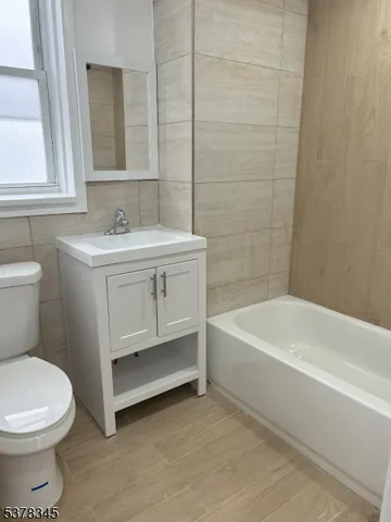 a bathroom with a sink a toilet and bathtub