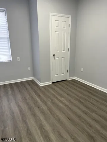 a view of wooden floor and windows in a room