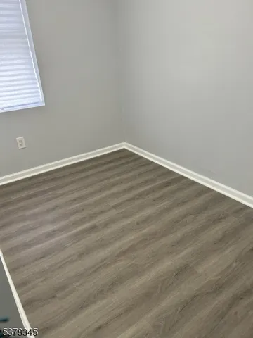 an empty room with wooden floor