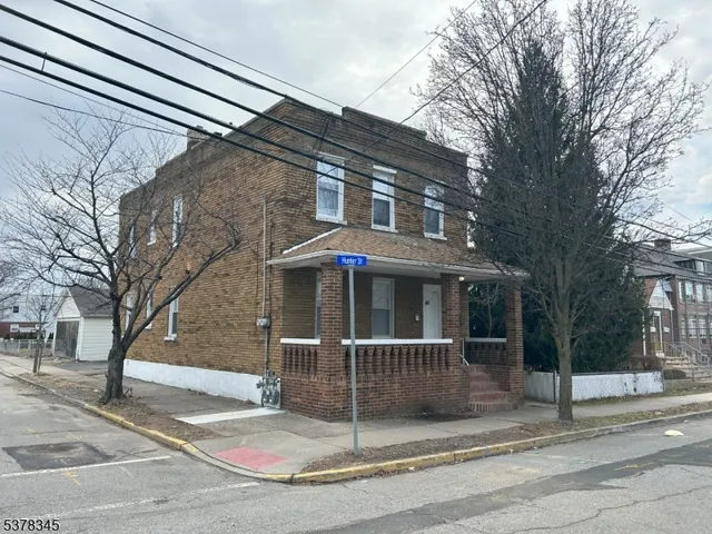 a view of a house with a large tree