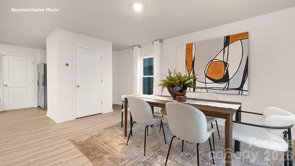 a dining room with furniture and wooden floor