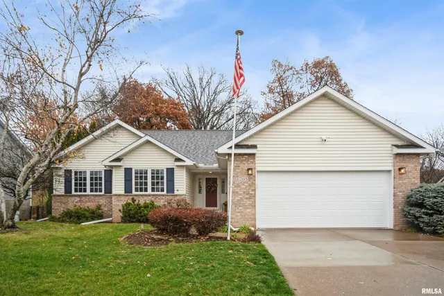 a front view of a house with a garden and plants