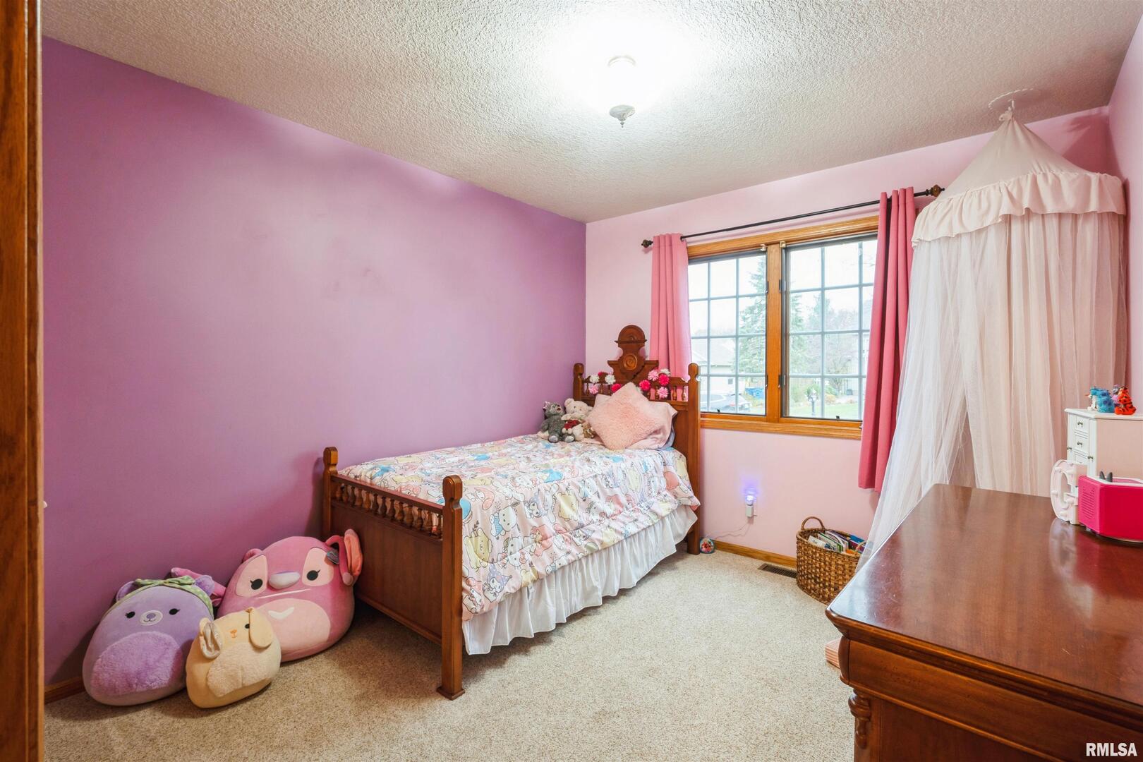 1205 28th Avenue Silvis, IL 61282 - Photo 12 of 24 a bedroom with a bed and a window