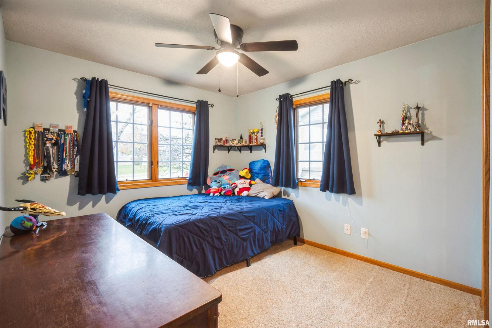 1205 28th Avenue Silvis, IL 61282 - Photo 15 of 24 a bed room with a bed and a window
