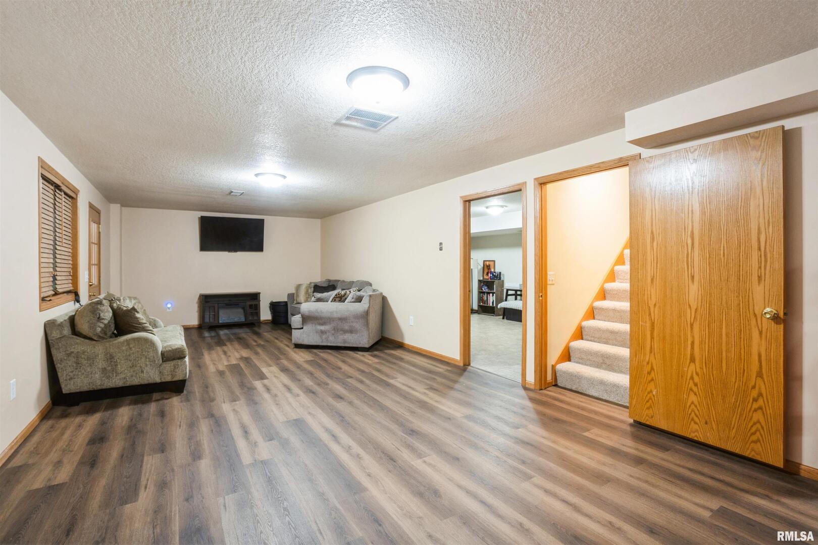 1205 28th Avenue Silvis, IL 61282 - Photo 17 of 24 a living room with furniture and a wooden floor
