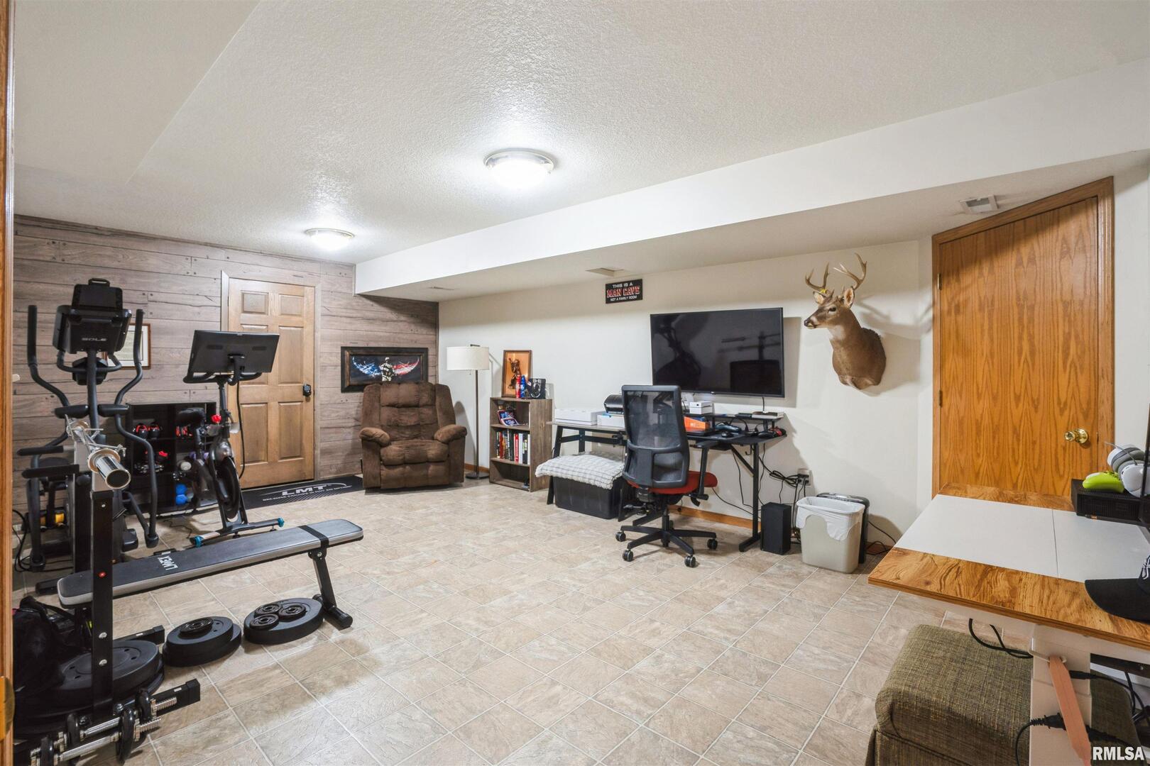 1205 28th Avenue Silvis, IL 61282 - Photo 18 of 24 a view of a room with gym equipment and a window
