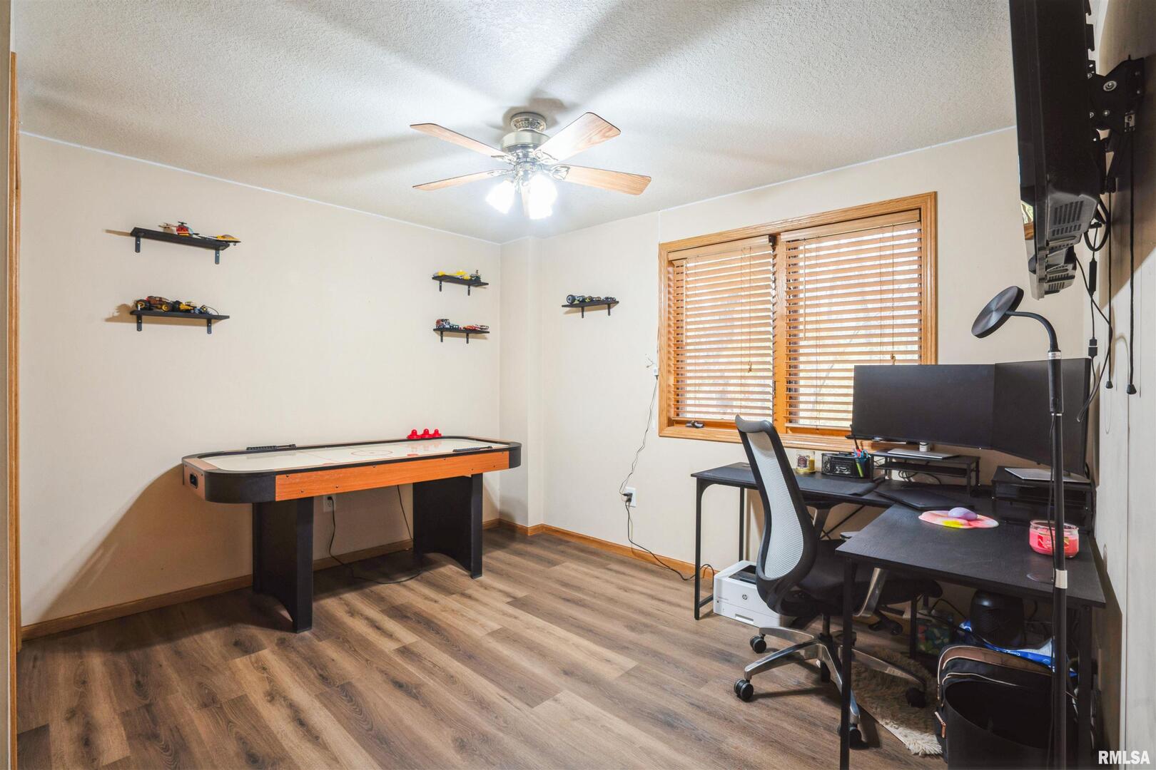 1205 28th Avenue Silvis, IL 61282 - Photo 19 of 24 a view of a workspace with furniture and a window