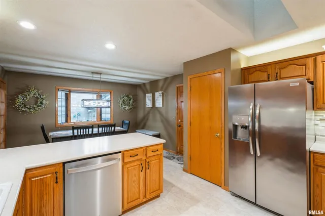 a kitchen with stainless steel appliances granite countertop a refrigerator a stove and a refrigerator