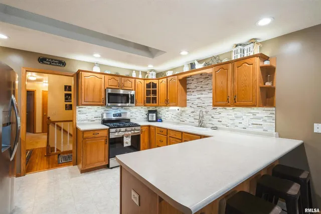 a kitchen with stainless steel appliances a sink and a refrigerator