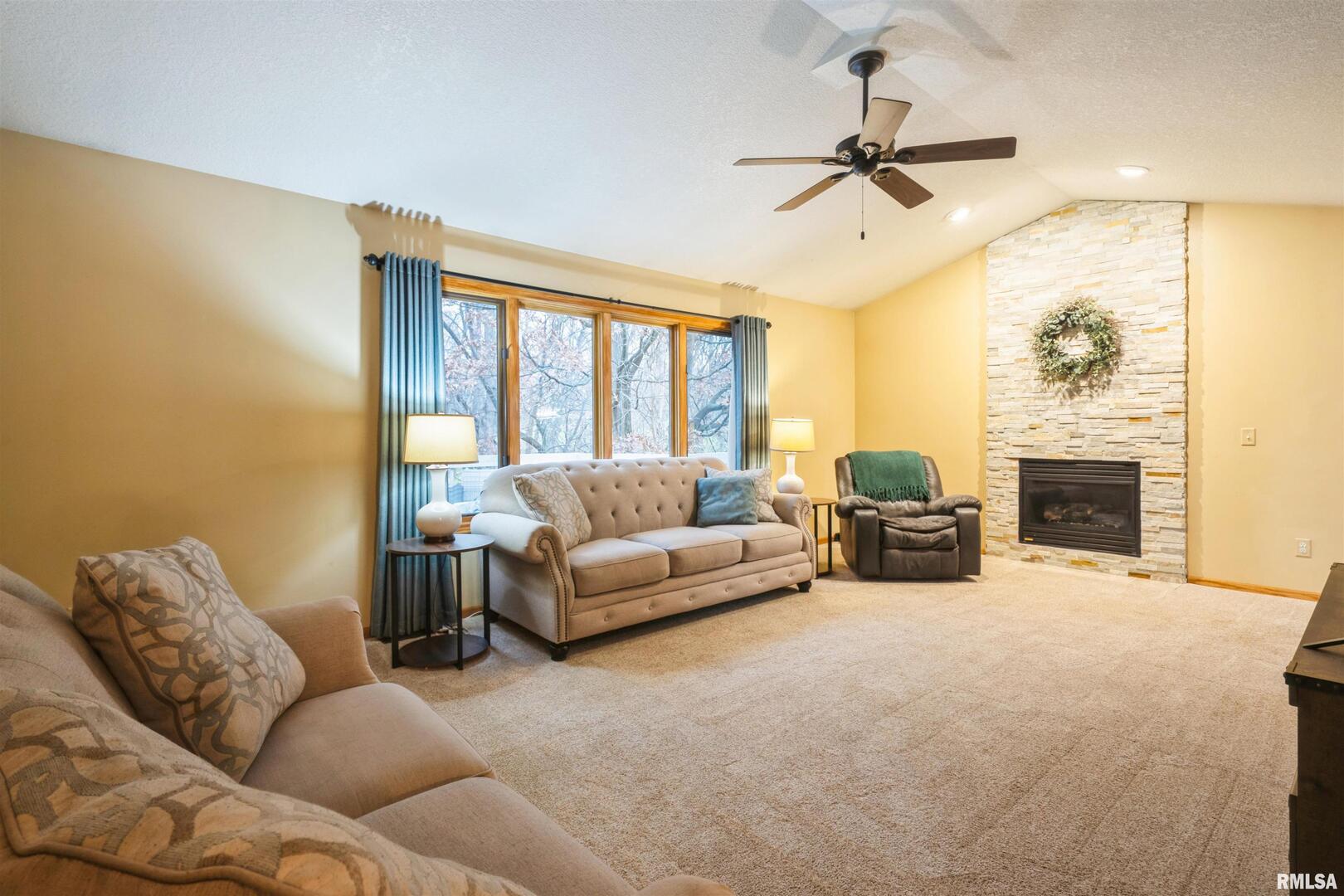 1205 28th Avenue Silvis, IL 61282 - Photo 8 of 24 a living room with furniture fireplace and a flat screen tv