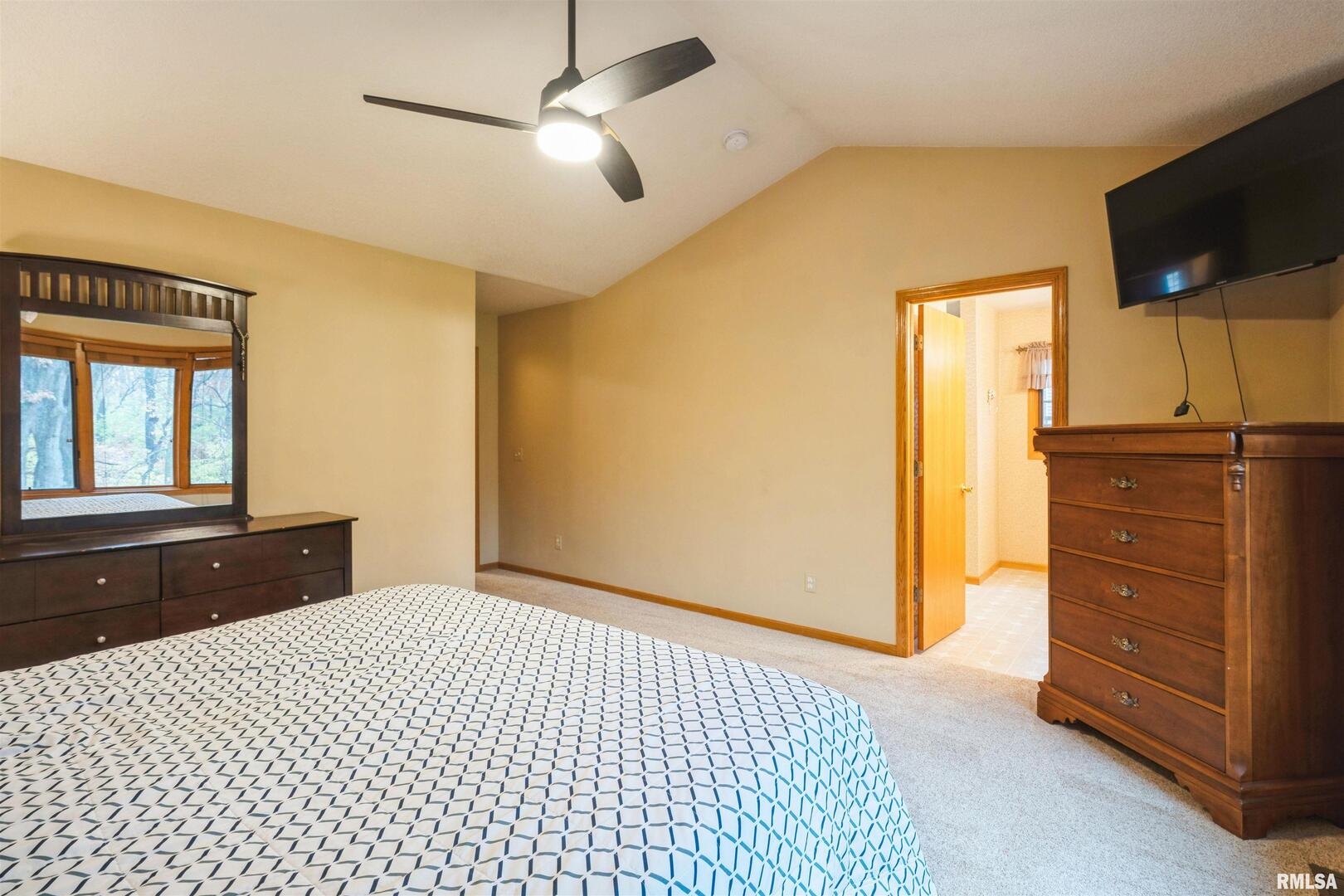 1205 28th Avenue Silvis, IL 61282 - Photo 10 of 24 a bedroom with a bed and a flat tv screen on dresser