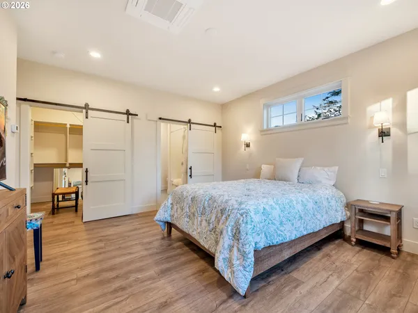 a spacious bathroom with double vanity a mirror and a bathtub