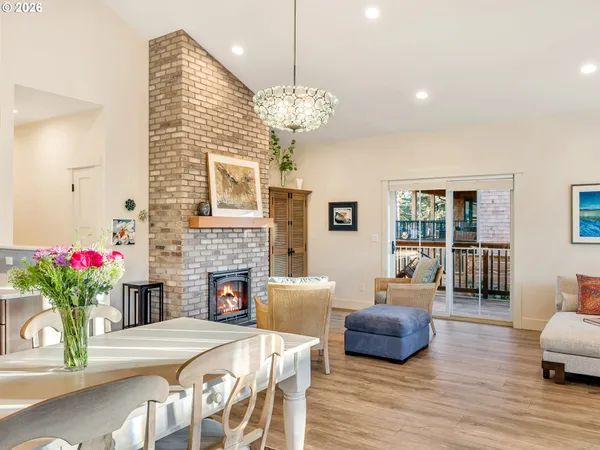 a living room with furniture a fireplace and a chandelier