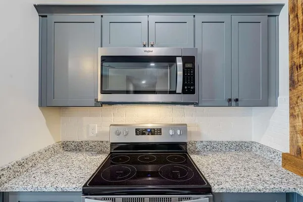 a stove top oven sitting inside of a kitchen