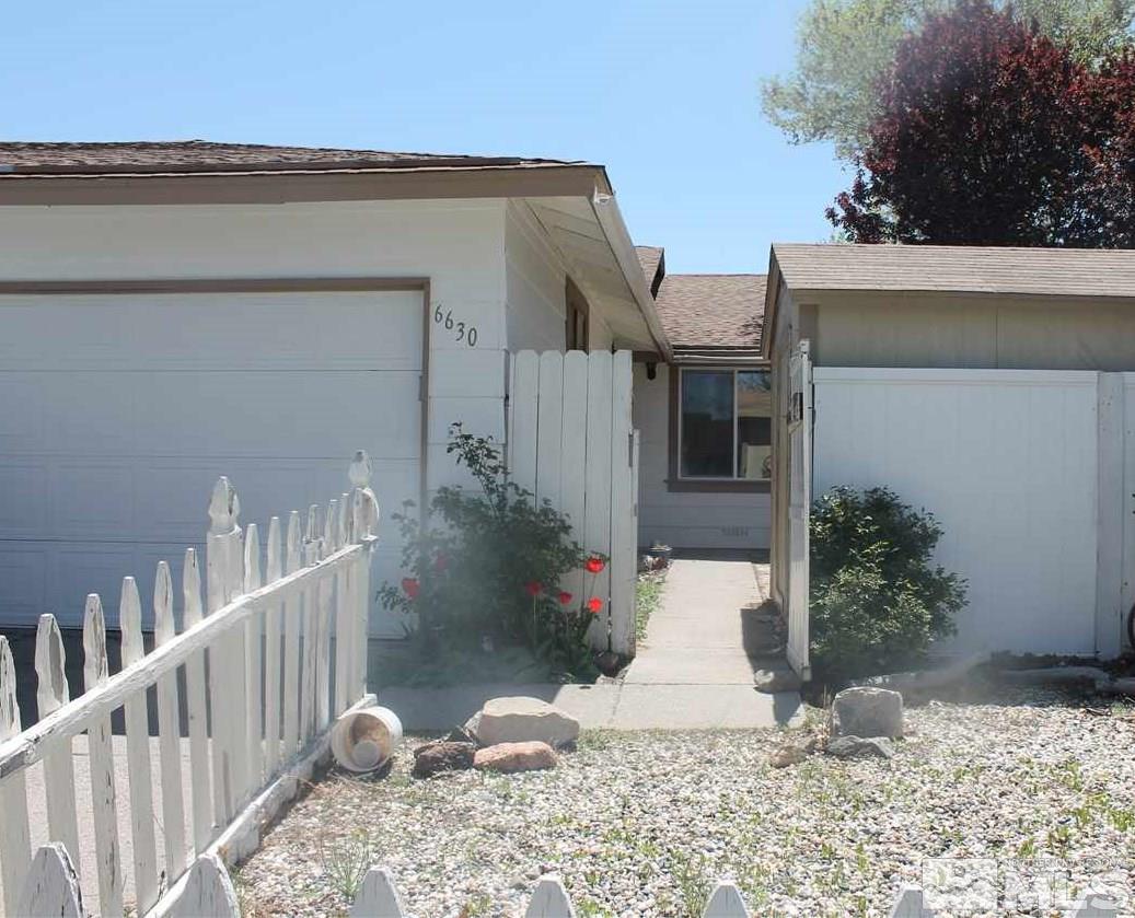 6630 Lotus Street Reno, NV 89506 - Photo 1 of 21 a view of a house with wooden fence