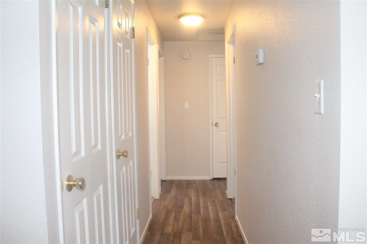 6630 Lotus Street Reno, NV 89506 - Photo 13 of 21 a view of a hallway with wooden floor