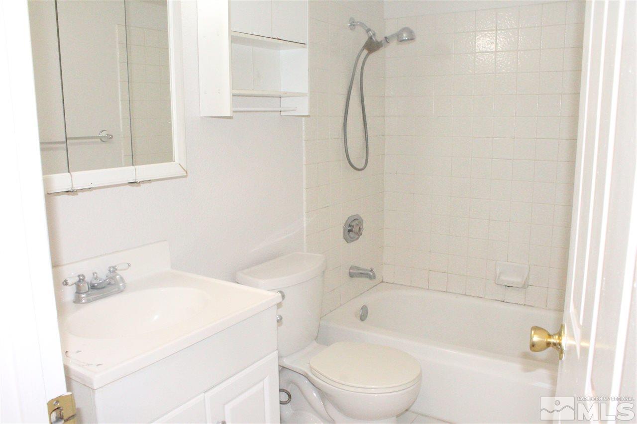 6630 Lotus Street Reno, NV 89506 - Photo 14 of 21 a bathroom with a sink a toilet and shower