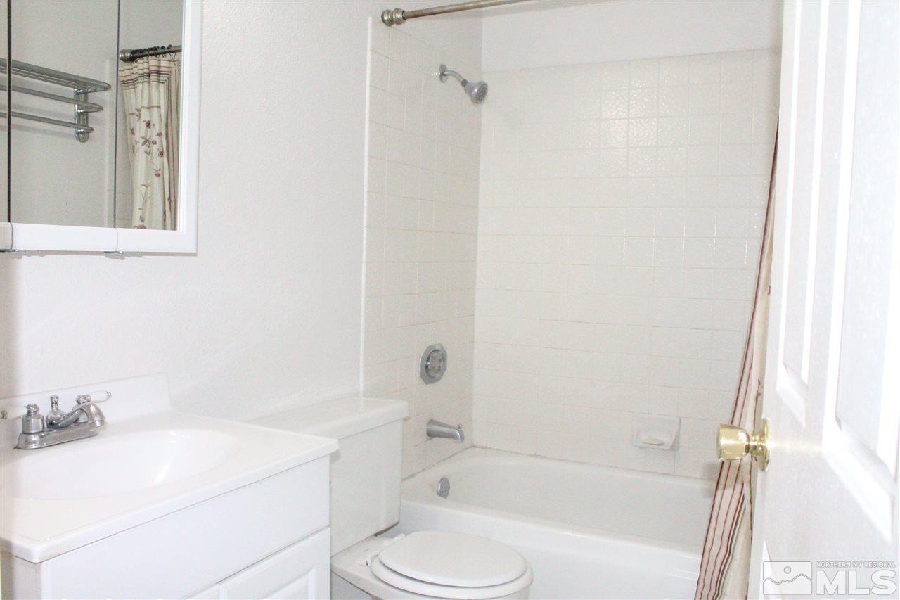 6630 Lotus Street Reno, NV 89506 - Photo 21 of 21 a bathroom with a granite countertop sink toilet and shower