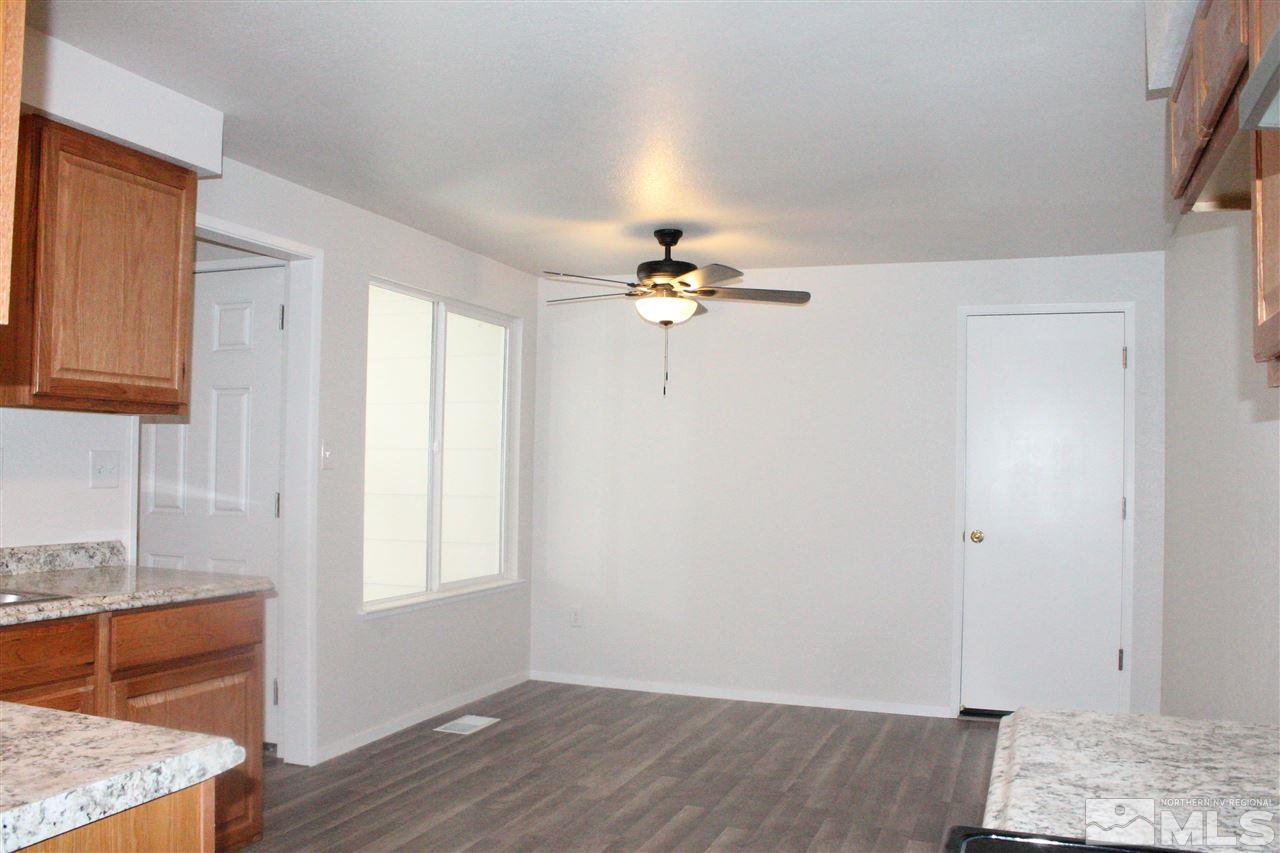 6630 Lotus Street Reno, NV 89506 - Photo 7 of 21 a view of an empty room with wooden floor and a window