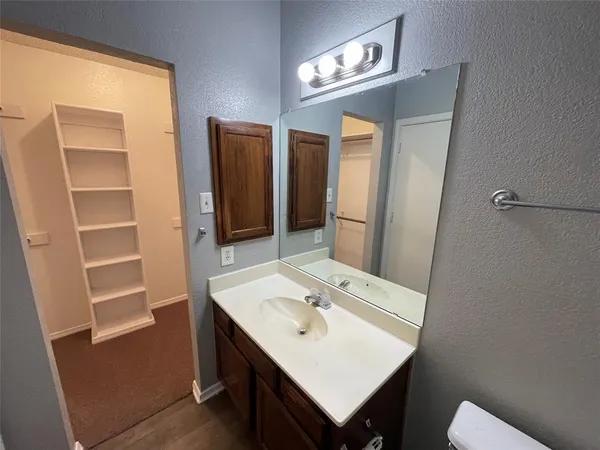 a bathroom with a sink a toilet and a mirror