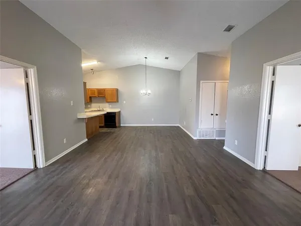 a view of a kitchen with wooden floor and a sink