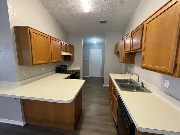 a kitchen that has a sink and a stove in it
