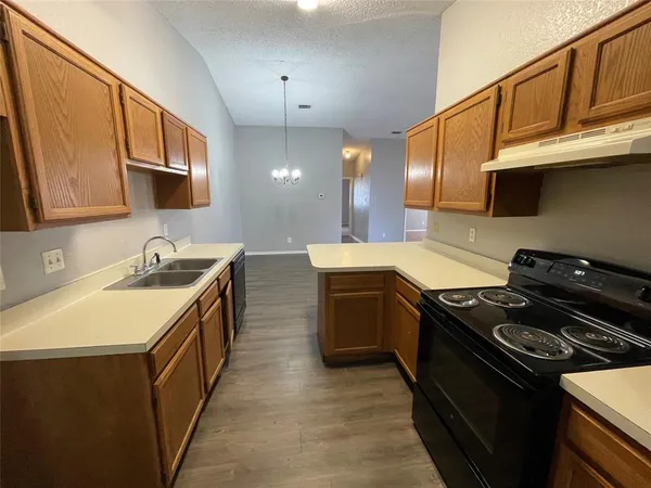 a kitchen with a stove and a sink