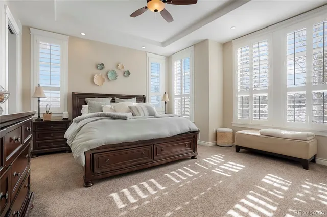 a kitchen with stainless steel appliances kitchen island granite countertop a table chairs in it and wooden floors